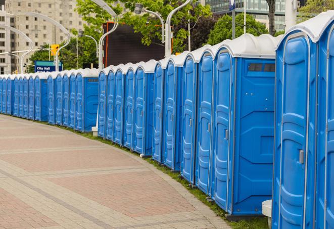 a row of portable restrooms at an outdoor special event, ready for use in Clawson